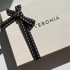 Caja de cartón con lazo negro y logotipo Veronia